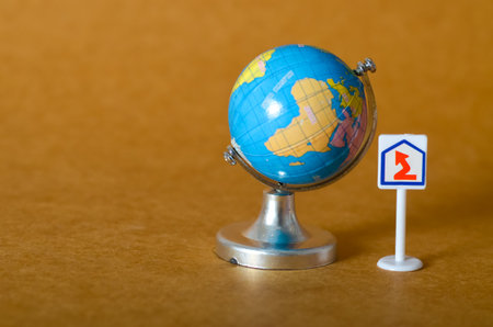 An arrow pointing up next to a world globe symbolizes worldwide growth, improvement, and a collective movement toward a better future.の写真素材