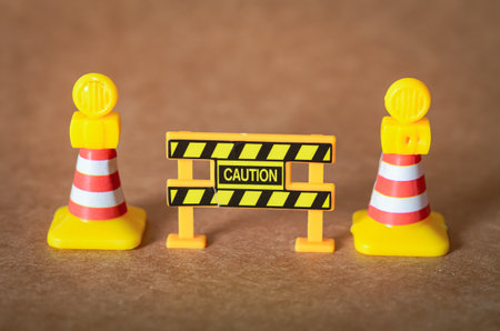 This conceptual image of a miniature safety barrier serves as a universal symbol for being mindful of dangers.の写真素材