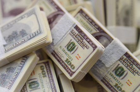The Appearance of Wealth: Piles of prop US dollars fill the frame, symbolizing the illusion of...
