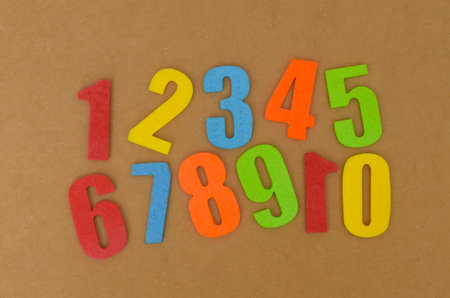 Colorful Felt Numbers for Learning: Bright digits from zero to ten, cut from colorful felt and arranged on a cardboard background, perfect for educational concepts.の写真素材
