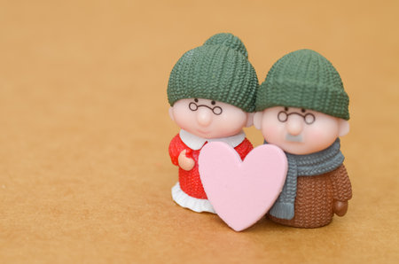 Love in Old Age: A symbolic image of an elderly couple with a heart, representing devotion, marriage, and a happy retirement.の写真素材