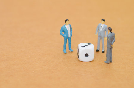Rolling the Dice on Business: A conceptual image of a team analyzing a game of chance, representing...