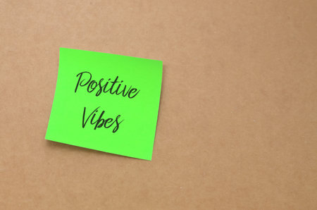 Positive Vibes Handwritten Note: A simple yet powerful message of optimism written in black text on...