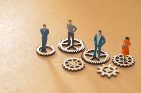 Teamwork and System Management Metaphor with Wooden Cogs and Figuresの写真素材