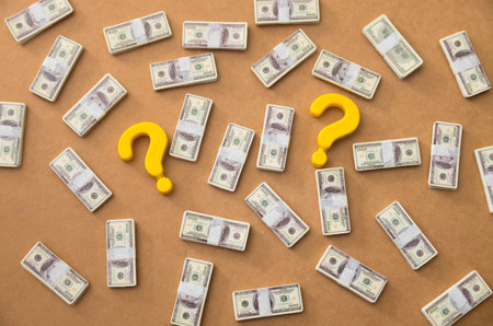 Investment Questions and Economic Doubt: Currency Bundles with Symbolの写真素材