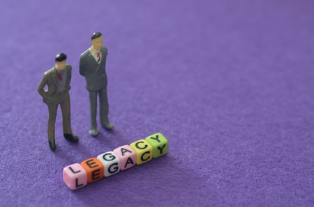 Business Leadership Concept: Figurines Contemplating the Word Legacyの写真素材
