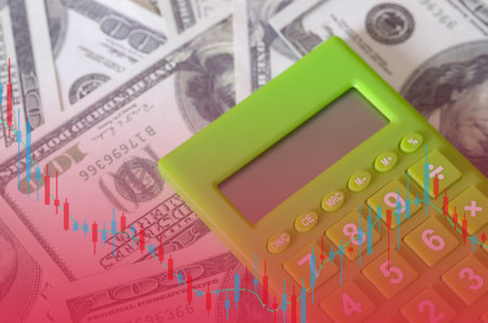 Market Volatility and Computation: Candlestick Chart Displayed Beneath a Bright Green Calculator and Stack of US Currencyの写真素材