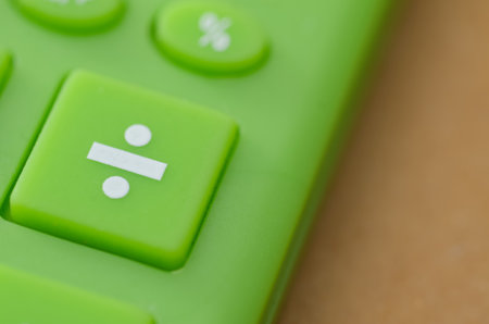 Mathematical Concept: Close-up of Divide Button on Bright Green Electronic Calculatorの写真素材