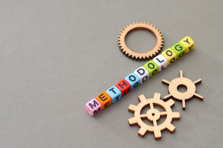 The Word "METHODOLOGY" Spelled in Colorful Beads with Decorative Cogs.の写真素材