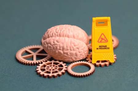 rain Model with Wooden Gears and Caution Sign Representing Mental Health Repair and Cognitive...