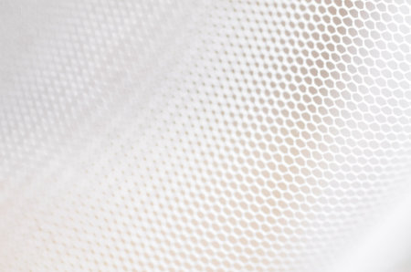 Macro Texture of White Hexagonal Mesh Fabric with Soft Lighting