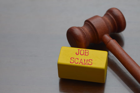 Judge Gavel on Laptop Keyboard Representing Legal Action Against Online Job Scams