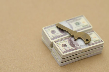 Vintage Key Placed on Cash Representing Financial Success Concept