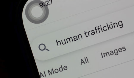 Close Up of Mobile Phone with Human Trafficking Text in Search Bar