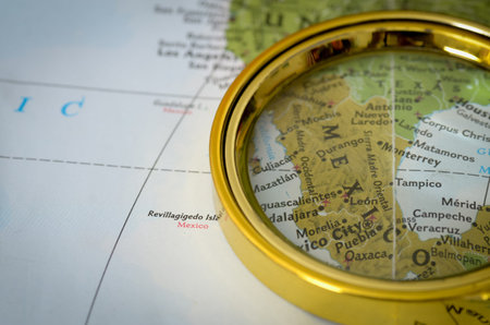 Magnifying Glass Highlighting Central Mexico Cities on Map with Focus on Security Risks