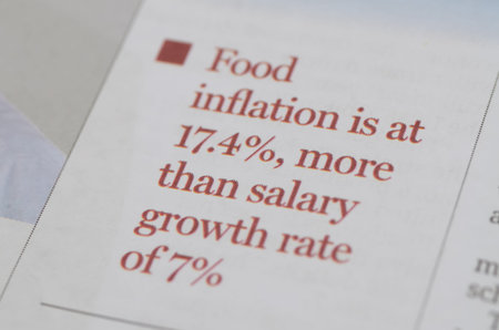 Newspaper print detailing food inflation and salary growth rates
