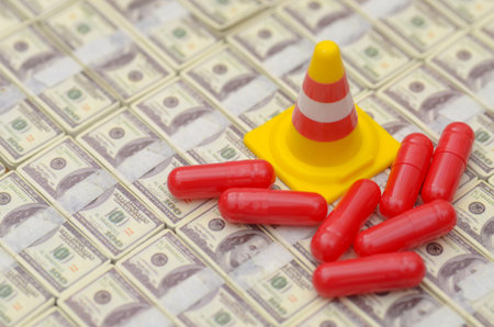 Conceptual Image of Healthcare Costs Red Pills on Stacks of Cash