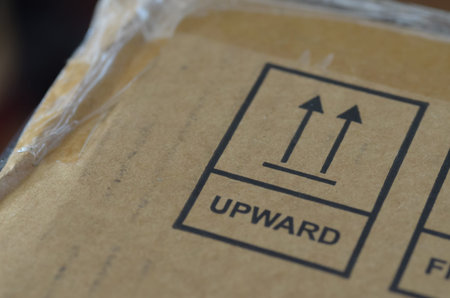 Upward directional arrows symbol on cardboard shipping box