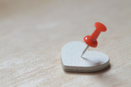 Conceptual image of heartbreak, emotional pain, or pinning down a location of love.