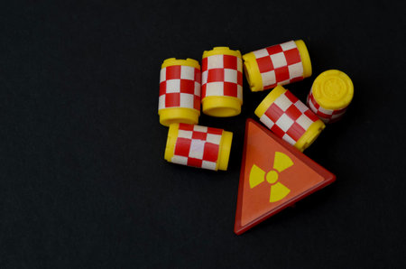 Radioactive Hazard Concept with Warning Sign and Miniature Waste Barrels