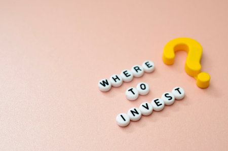 Letter Beads Spelling Where to Invest with Yellow Question Mark for Financial Guidance