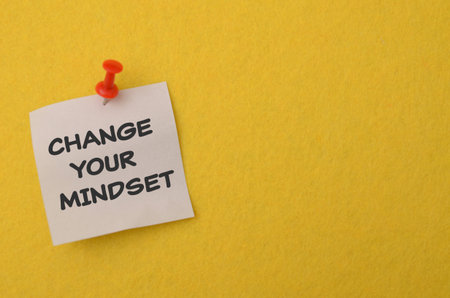 Change your mindset text on a sticky note pinned to a yellow background