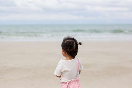 Little asian girl playing on Kayak . Playing on the Kayak  summer beach near the sea. Summer or...