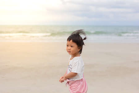 Little asian girl playing on Kayak . Playing on the Kayak  summer beach near the sea. Summer or Travel or Holiday conceptの写真素材