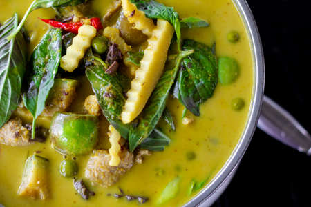 Thai food chicken green curry on dark wooden background. top viewの写真素材