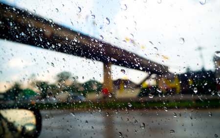 Rain and dew drop on the car glass window during raining. Dew is the moisture that forms as a result of condensation.の写真素材