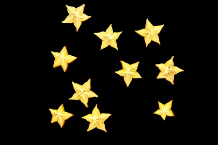 The Starry Night. Slices of starfruit (carambola) on a black background looking like a night sky.の写真素材
