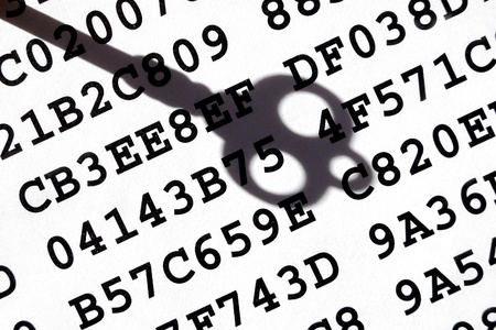 A sheet with encrypted data with a shadow of old-fashioned key