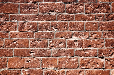 Fragment of a wall made of rough bricks