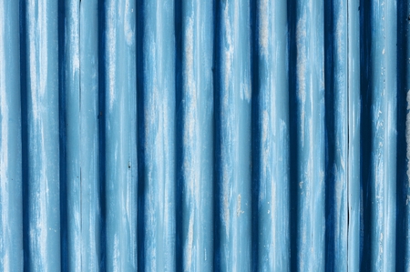 Corrugated metal sheet fence with peeling away paintの写真素材