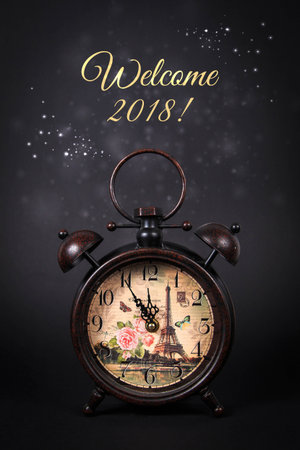 Close up of an old vintage watch, with the message Welcome 2018 and sparkles