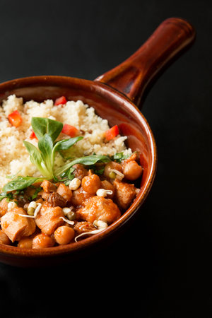 Close up of a Tajine, Morocco meal on a black tableの写真素材