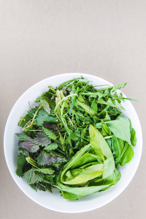 Fresh raw greens in a white bowlの写真素材