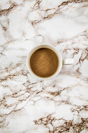 Coffee in a white mug on a marble backgroundの写真素材