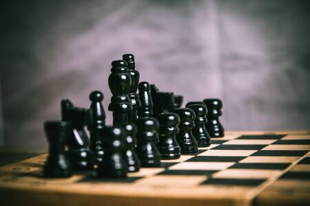 Scene of a black chess figures on a chess boardの写真素材