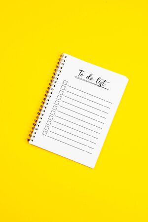 Piece of paper with to do list on it, on a yellow backgroundの写真素材