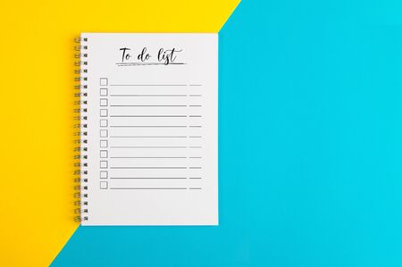 To do list on a yellow and blue backgroundの写真素材