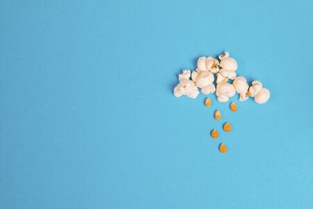 Rainy cloud made out of popcorn on a blue backgroundの写真素材
