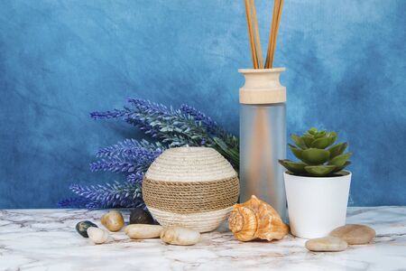 Spa objects and elements on a marble table and blue backgroundの写真素材