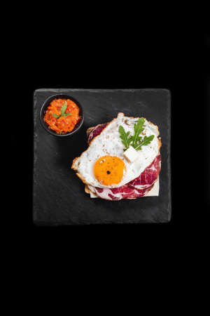 Healthy breakfast with eggs, dry meat and vegetablesの写真素材