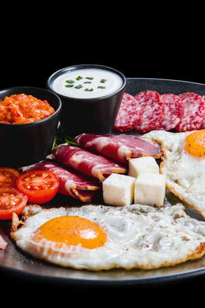 Healthy breakfast with eggs, dry meat and vegetablesの写真素材