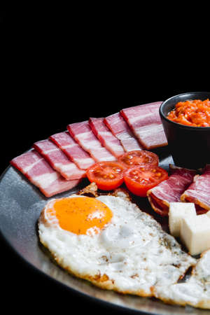 Healthy breakfast with eggs, dry meat and vegetablesの写真素材