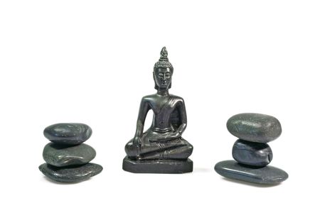 Black buddha statue with black stones on white backgroundの写真素材