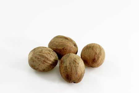Close up of four whole nutmegsの写真素材