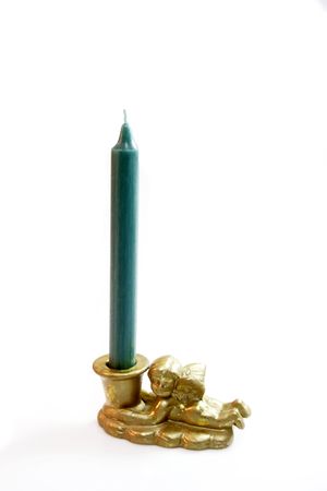 Green candle in angel candleholder on light backgroundの写真素材