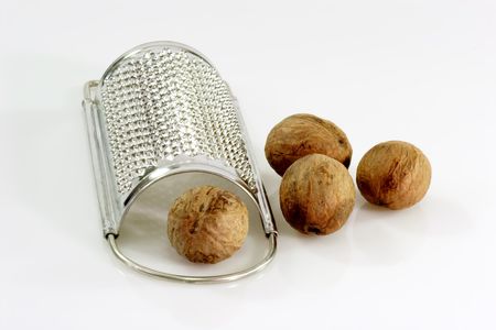 Close up of four nutmegs with a graterの写真素材